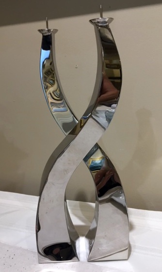 A Pair of Polished Steel Candlesticks